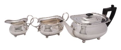 A matched Edwardian silver three piece tea service by William Hutton & Sons Ltd,