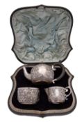 A late Victorian silver three piece bachelor's tea service by James Wakely & Frank Clarke Wheeler,