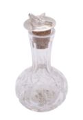 A silver mounted cut glass Angostura bitters bottle by Barker Ellis Silver Co.