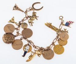 A gold bracelet with charms, including a pair of skis, Eiffel tower,