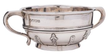 A silver twin handled christening bowl by Jay, Richard Attenborough Co Ltd, Chester 1914,