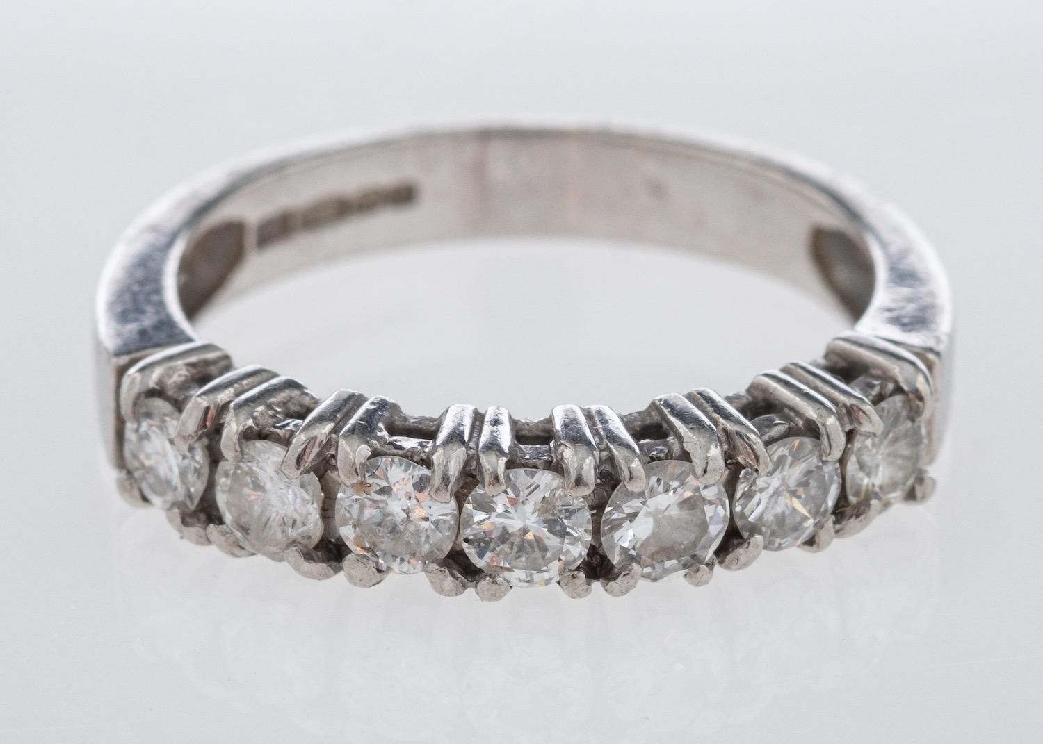 A platinum diamond half eternity ring set with round brilliant cut stones in platinum,