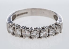 A platinum diamond half eternity ring set with round brilliant cut stones in platinum,