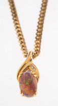 A pendant set with opal and small diamonds in unmarked yellow metal,