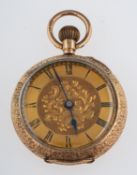 An engraved 12ct gold lady's fob watch the engraved gold dial with black Roman numerals and blued