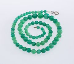 A Jadeite jade bead necklace, beads graduating in size from 5 to 12 mm, strung to a bolt ring clasp,