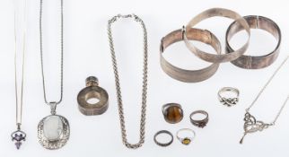 A group of silver jewellery, three silver bangles with engraved or engine turned decoration,