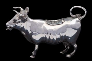 A late Victorian silver cow creamer by Maurice Freeman, London 1900, with a bee to the hinged cover,