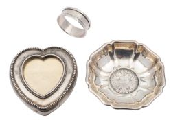 A silver coloured heart-shaped jar cover, stamped STERLING 2569, possibly American,