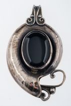 A large vintage silver and onyx pendant, with cabouchon stone and stylized tendrils,