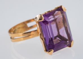A vintage cocktail ring set with a large amethyst in hand crafted gold mount,