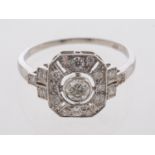 A platinum openwork set plaque ring in millgrain setting, centre stone estimated at 0.