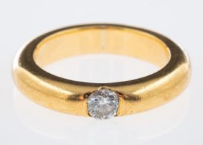 A heavy gold band ring single stone diamond ring inset with a diamond of 0.