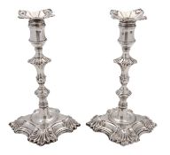 A pair of late George II cast silver candlesticks by William Cafe, London 1759,