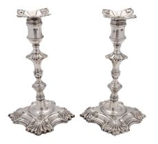 A pair of late George II cast silver candlesticks by William Cafe, London 1759,