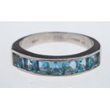 A modern aquamarine set ring, the square cut stones channel set in 18ct white gold,