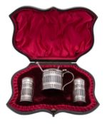 An Edwardian silver three piece cruet set by Atkin Brothers, Sheffield 1901, pierced cylindrical,