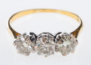 A three stone diamond ring set with brilliant cut diamonds in 18ct white and yellow gold,