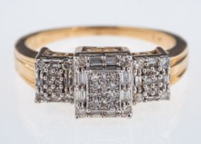 An Art Deco style diamond set ring pave set with small diamonds in a three square setting,