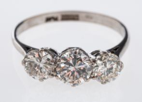 A three stone diamond ring, the principle brilliant cut diamond of approximately 1 carat,