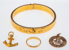 A small group of yellow metal items with Oriental marks, anchor and disk pendant,