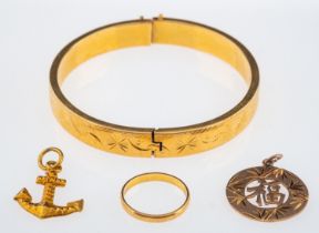A small group of yellow metal items with Oriental marks, anchor and disk pendant,