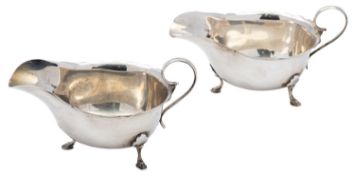 A pair of silver sauce boats by Mappin & Webb, Birmingham 1920, oval with scroll handles,