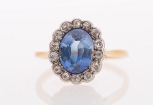 A sapphire & diamond ring, the oval faceted sapphire of good colour measuring 8.5 x 6.