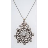 An antique diamond pendant C1910, the central floral setting with a diamond of 0.