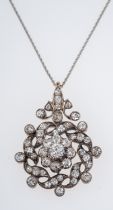 An antique diamond pendant C1910, the central floral setting with a diamond of 0.