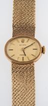 Rolex a lady's 9ct gold wristwatch the oval dial with raised baton numerals,