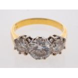 An 18ct gold diamond three stone ring, the central brilliant cut diamond, estimated to weigh 1.