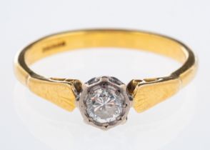 A gold ring with single diamond in illusion setting, diamond estimated at 0.