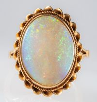 An opal dress ring in gold mount with rope twist edge, 9ct, ring size K-L , 3.