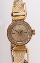 Omega a lady's wristwatch the dial with raised baton numerals and glazed bezel,