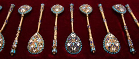 A part set of eleven Russian silver gilt and enamelled small spoons by Sergi Shaposhnikov