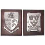 A pair of silver plated copper and oak mounted wall hanging armorials by Fisher & Ludlow Ltd,