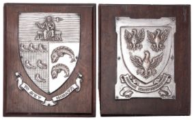 A pair of silver plated copper and oak mounted wall hanging armorials by Fisher & Ludlow Ltd,