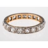 A diamond eternity ring, set with old cut diamonds, with an engraved border,