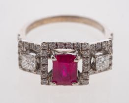 A 1940's style ruby and diamond ring with central step cut ruby and square cut diamonds,