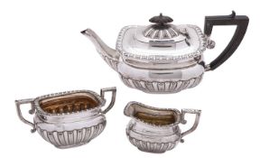 An Edwardian silver three piece tea service by Elkington and Co.