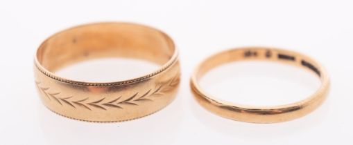 A gold wedding band with leaf form engraving, London 1987 3.