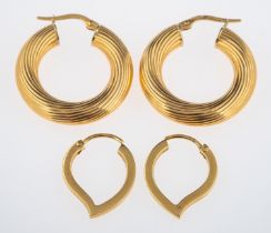 A pair of gold hoop earrings with ribbed design and another pair tear form,