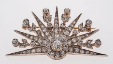 An antique sun burst brooch, modelled as pointed rays and flowers,