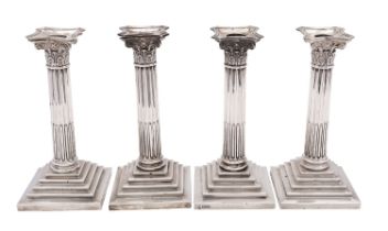 A pair of Edwardian silver Corinthian column candlesticks by The Goldsmiths & Silversmiths Co.