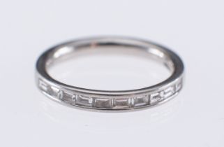 A platinum eternity ring channel set with baguette diamonds,