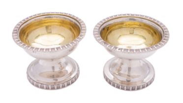 A pair of George III Scottish silver spool shaped salt cellars by James Downie, Glasgow 1819,