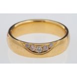 Nuran Denmark, a contemporary gold band ring with wave design inset with diamonds, 14 ct gold,