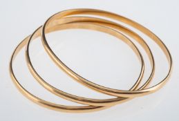 Three yellow metal D form bangles, testing as 9ct gold, internal measurement 6cm, weight 34.