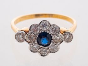 A modern daisy set sapphire & diamond ring in 18ct gold.